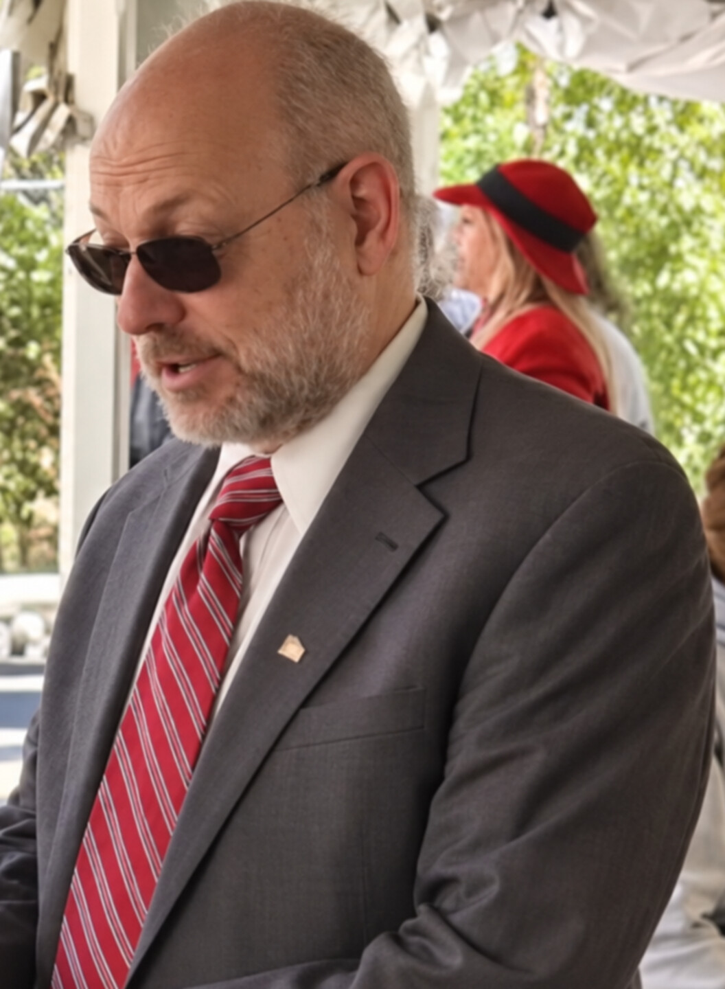 Gregg Mele speaking with voters at an outdoor campaign event